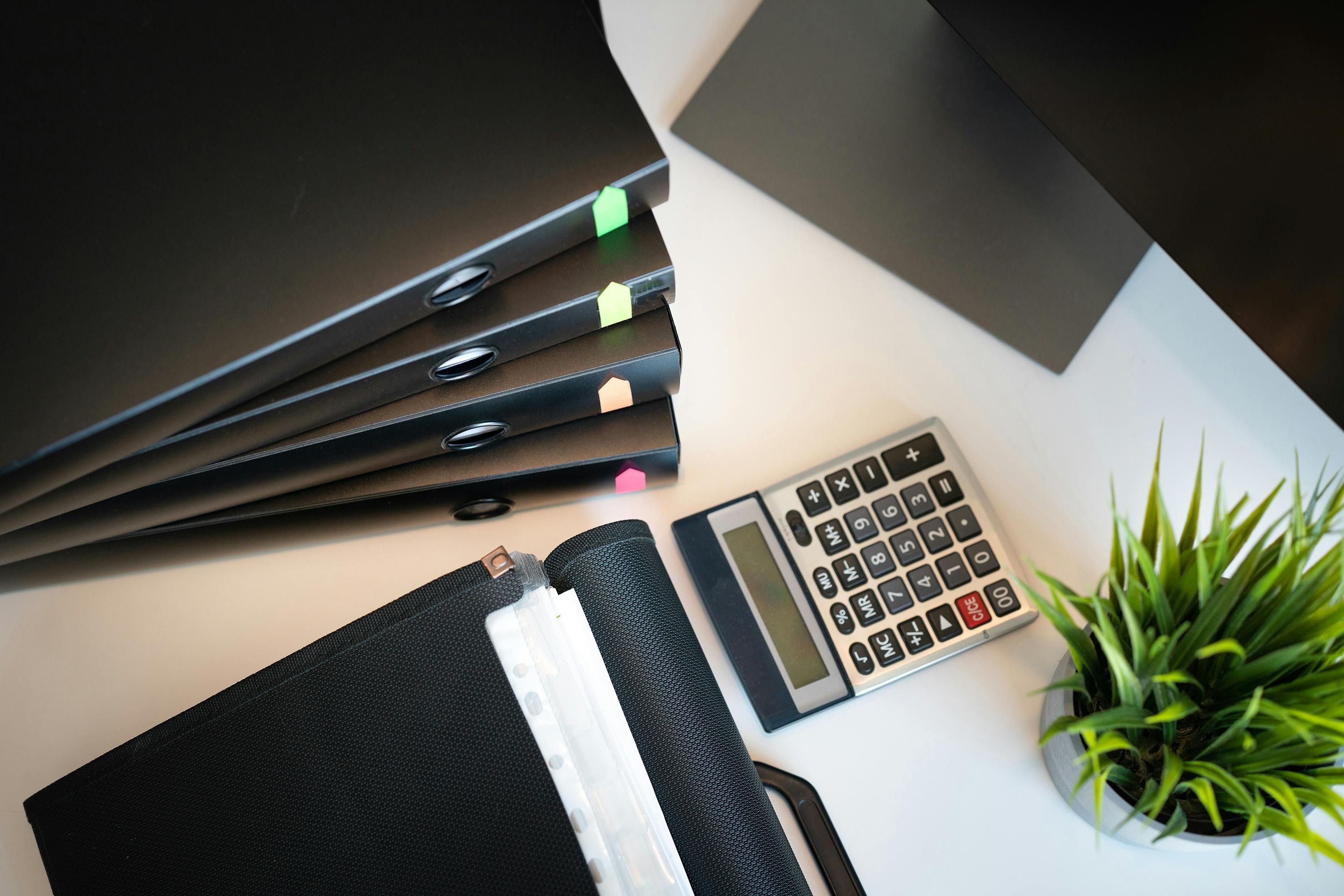 Documents, calculator, and folders for tax and administrative support.